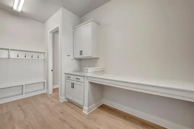 a kitchen with stainless steel appliances granite countertop a sink a stove and a wooden floors