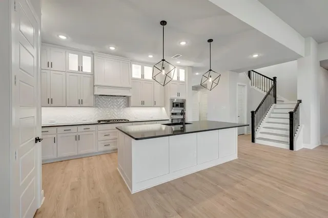 a kitchen with granite countertop a stove and a sink