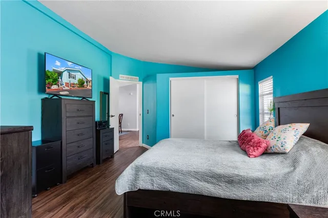 a bedroom with a bed and a flat screen tv