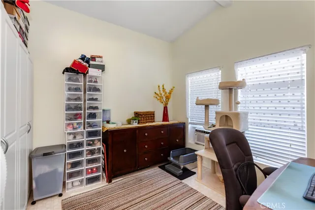 a view of a workspace with furniture and a window