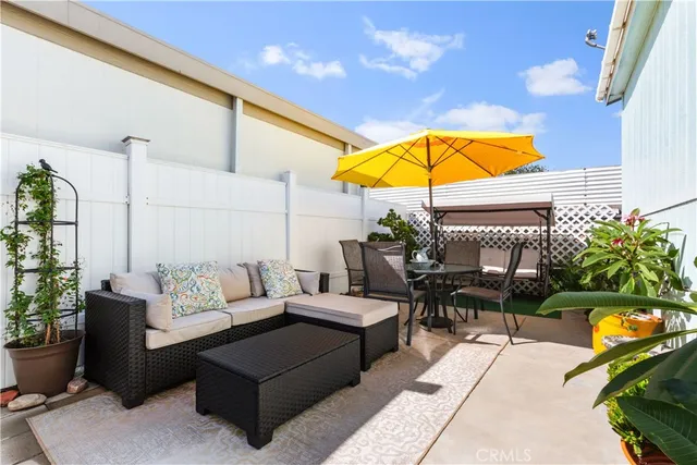 a living room with furniture a patio and a garden