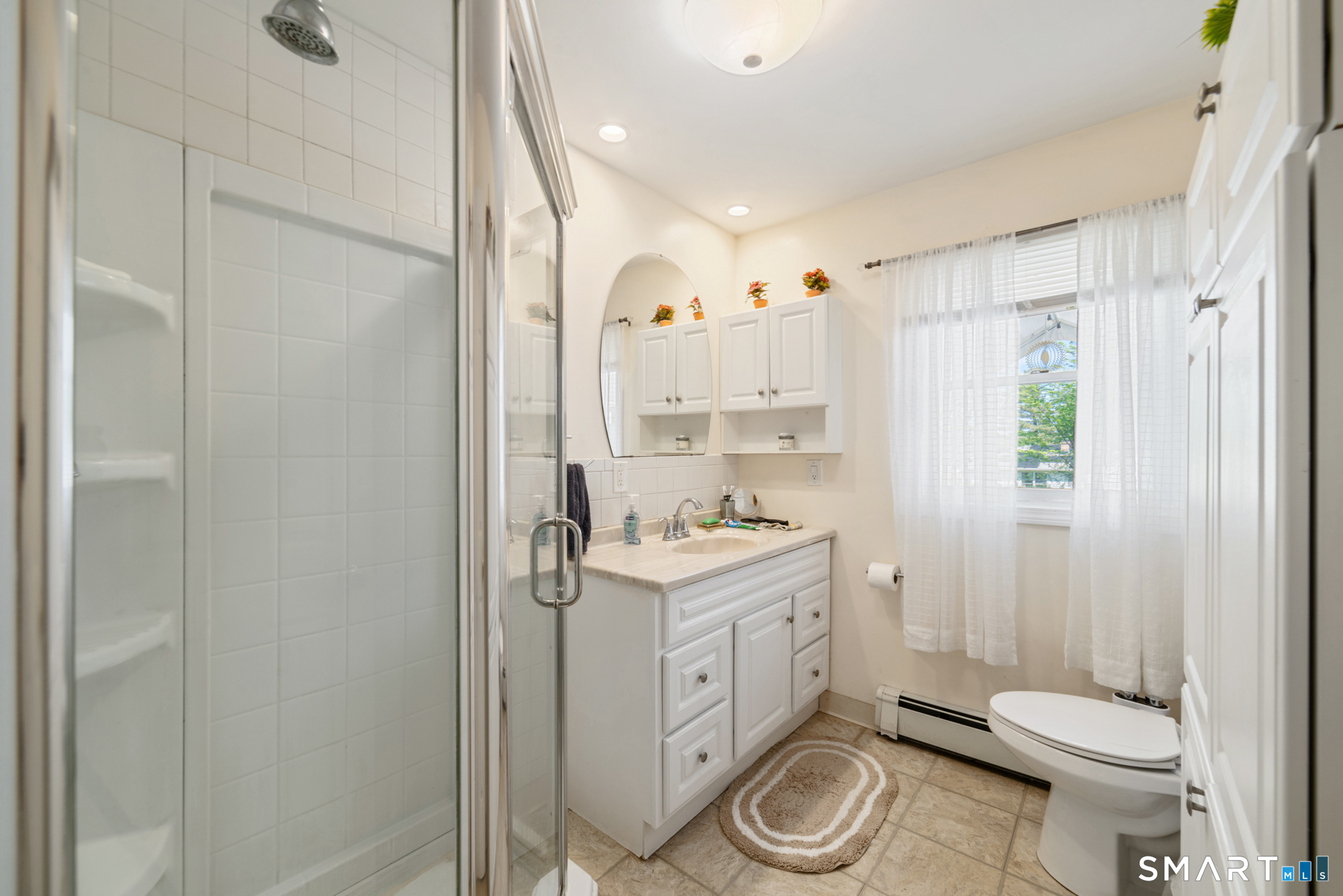 146 Highland Drive Waterbury, CT 06708 - Photo 11 of 31 a bathroom with a granite countertop toilet a sink and a shower