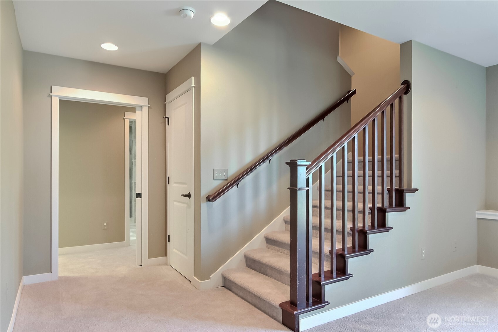 1207 Adams Street Steilacoom, WA 98388 - Photo 14 of 25 a view of staircase with lots of frames on wall and wooden floor