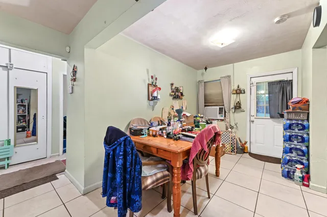 a view of a dining room with furniture and a chandelier
