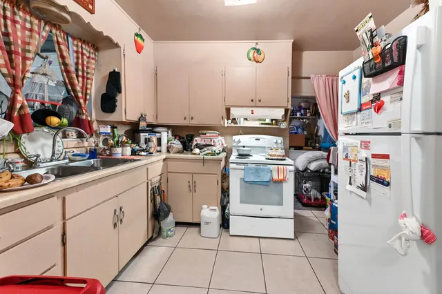 a kitchen with a sink and white cabinets