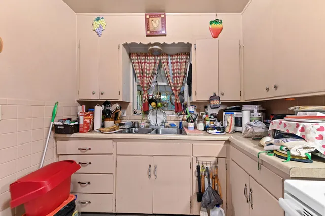 a kitchen with a sink cabinets and window