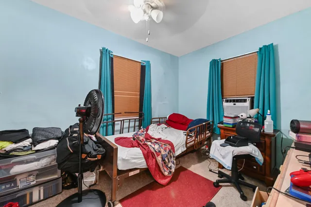 a bedroom with furniture and a flat screen tv