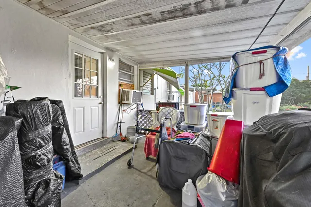 a living room with furniture a flat screen tv and a floor to ceiling window
