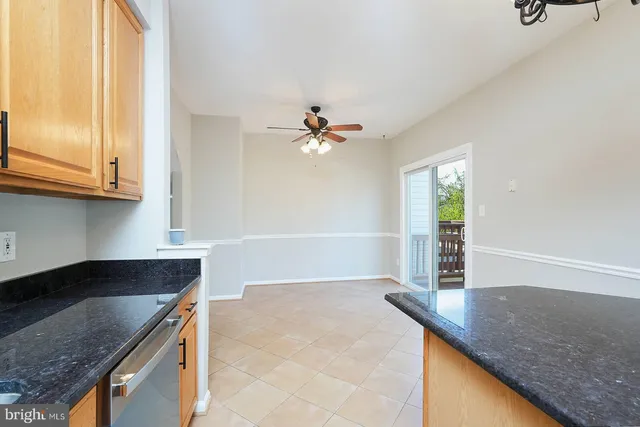 a kitchen with granite countertop a sink a stove and cabinets