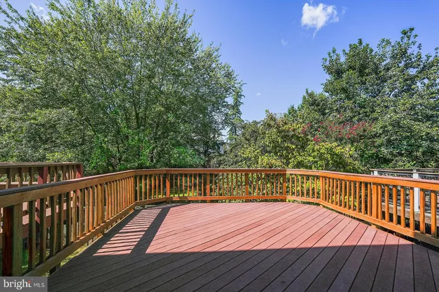 a view of balcony with wooden floor and fence