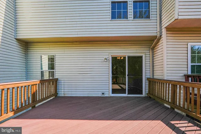 a view of a house with wooden deck