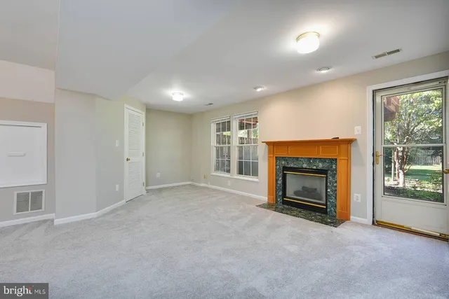 a view of empty room with a fireplace