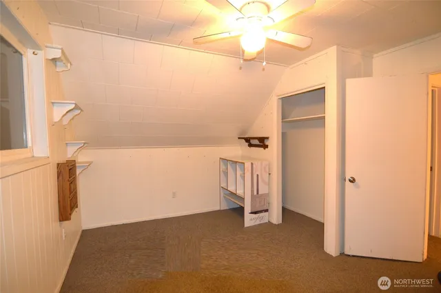 a bathroom with a granite countertop sink a mirror and shower