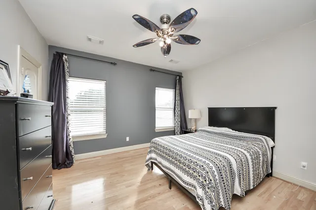 a bedroom with a bed and wooden floor