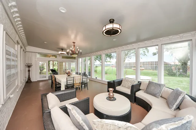 a view of a patio with a table chairs and a yard