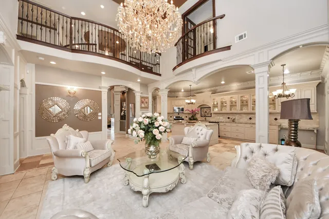 a living room with furniture and a chandelier