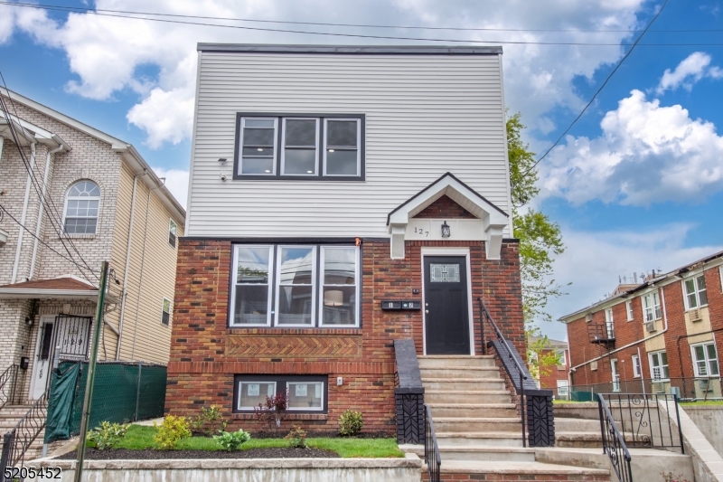 127 21st Street Irvington, NJ 07111 - Photo 1 of 29 a view of a brick house with large windows