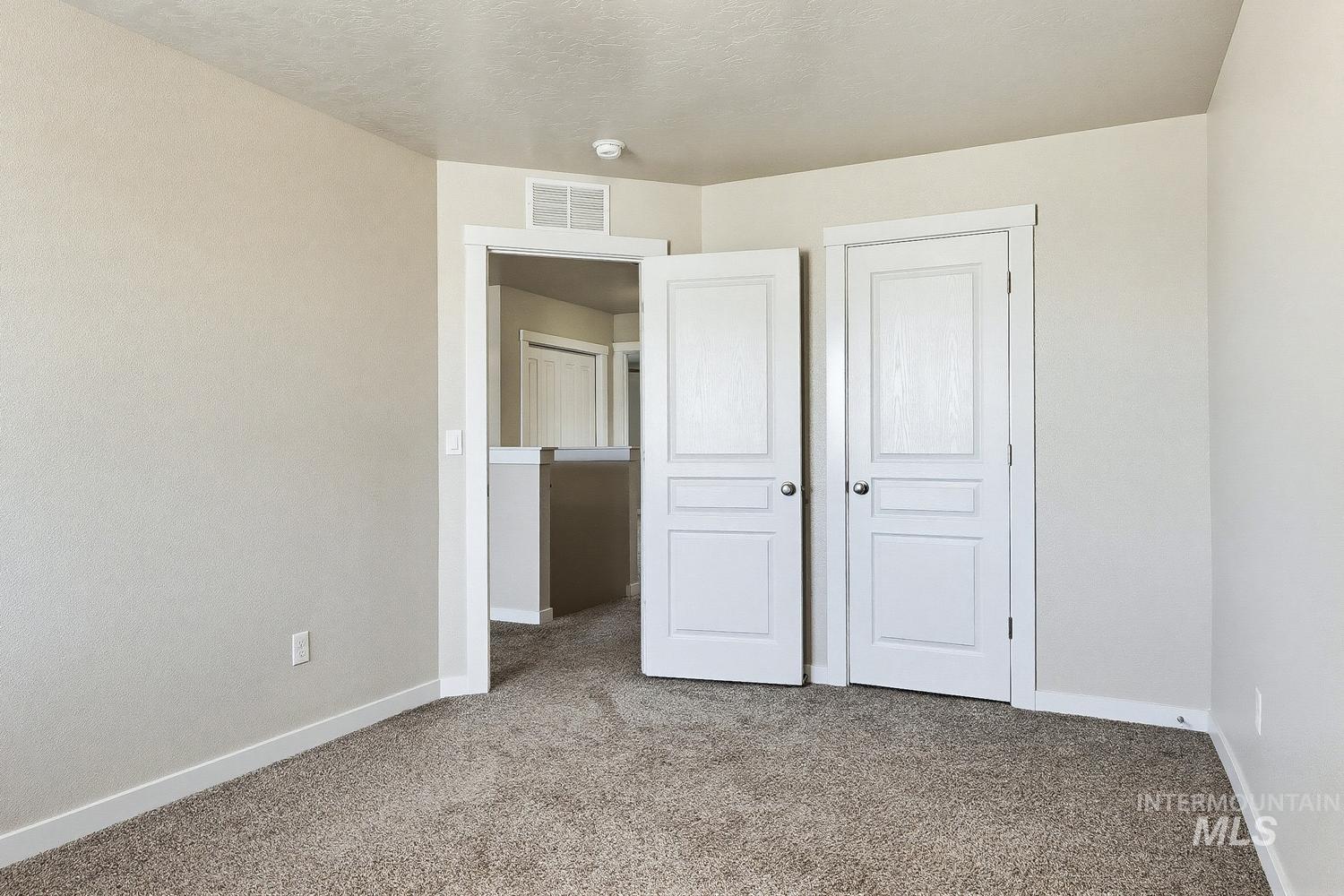 846 North Hidden View Way Star, ID 83669 - Photo 41 of 49 Neutral-toned walls complement the textured brown carpeting