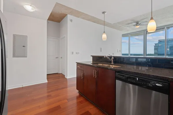 a bathroom with a granite countertop sink and white cabinets