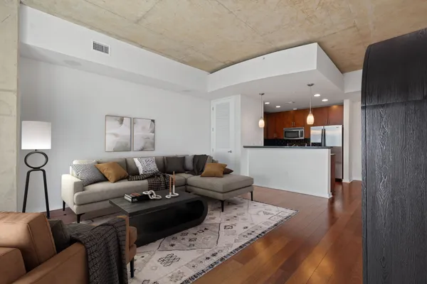 a kitchen with stainless steel appliances granite countertop a refrigerator a sink and a stove