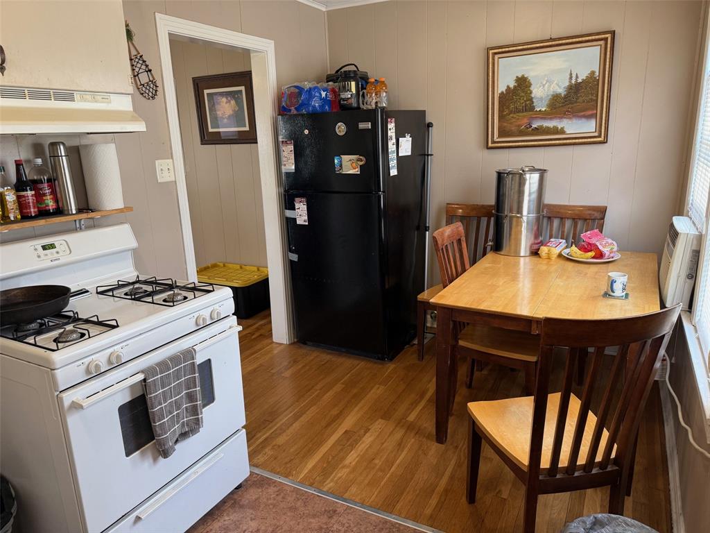 1716 Sheppard Street Waco, TX 76711 - Photo 4 of 13 a kitchen with stainless steel appliances granite countertop a stove a refrigerator a dining table and chairs