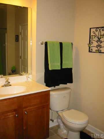 844 Horton Road, Unit 20 Durham, NC 27704 - Photo 8 of 9 a bathroom with a toilet sink and mirror