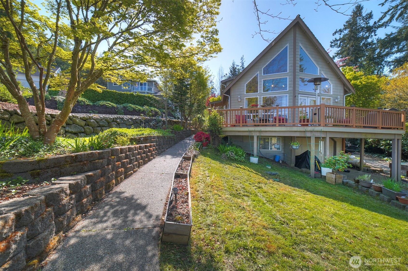 a view of a house with a yard and potted plants