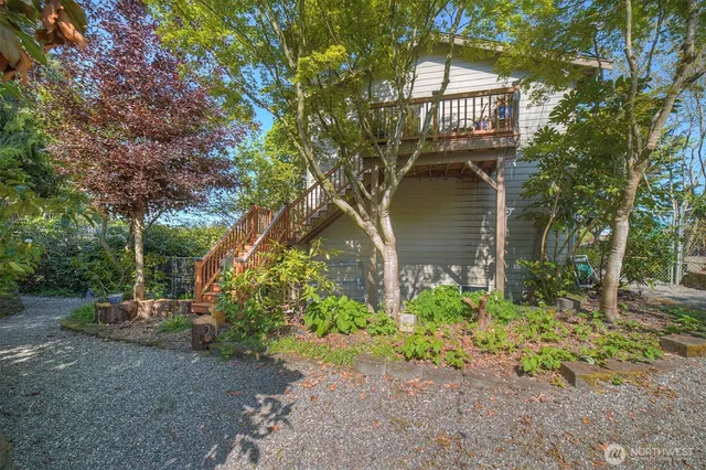 a backyard of a house with table and chairs