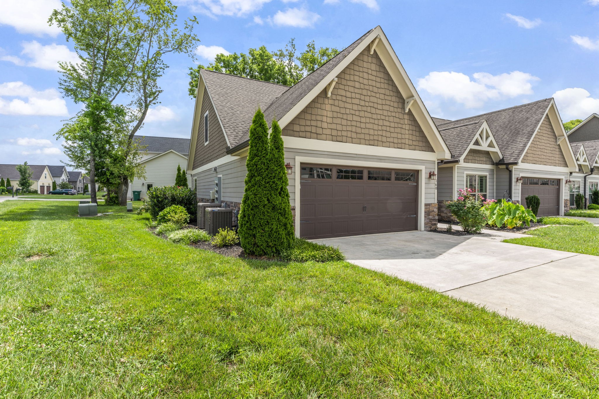 front view of a house and a yard and trees