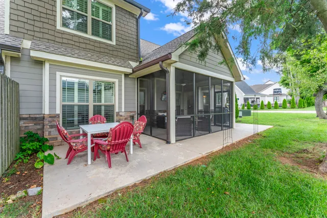 a view of a house with backyard sitting area and garden