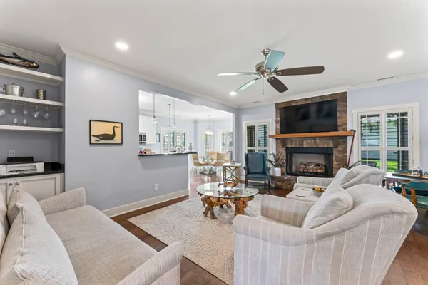 a living room with furniture a fireplace and a flat screen tv