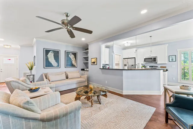 a living room with furniture and kitchen view