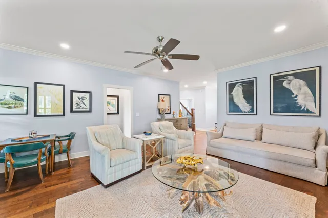a living room with furniture a rug and a table