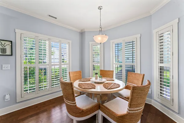 a view of a dining room with furniture window and wooden floor