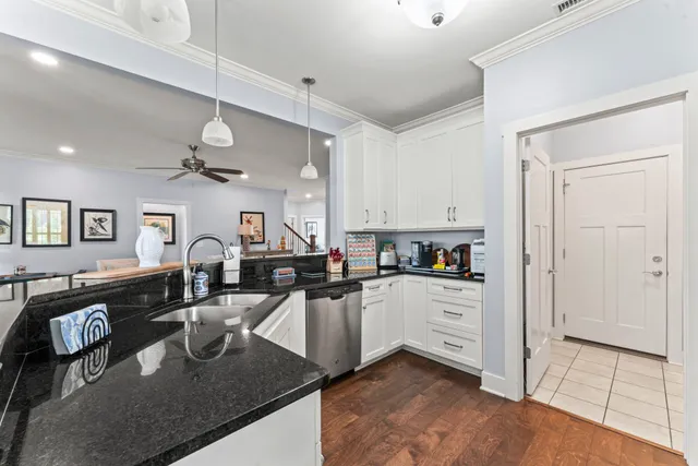 a kitchen with sink refrigerator and cabinets