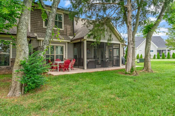 a view of a house with backyard porch and sitting area