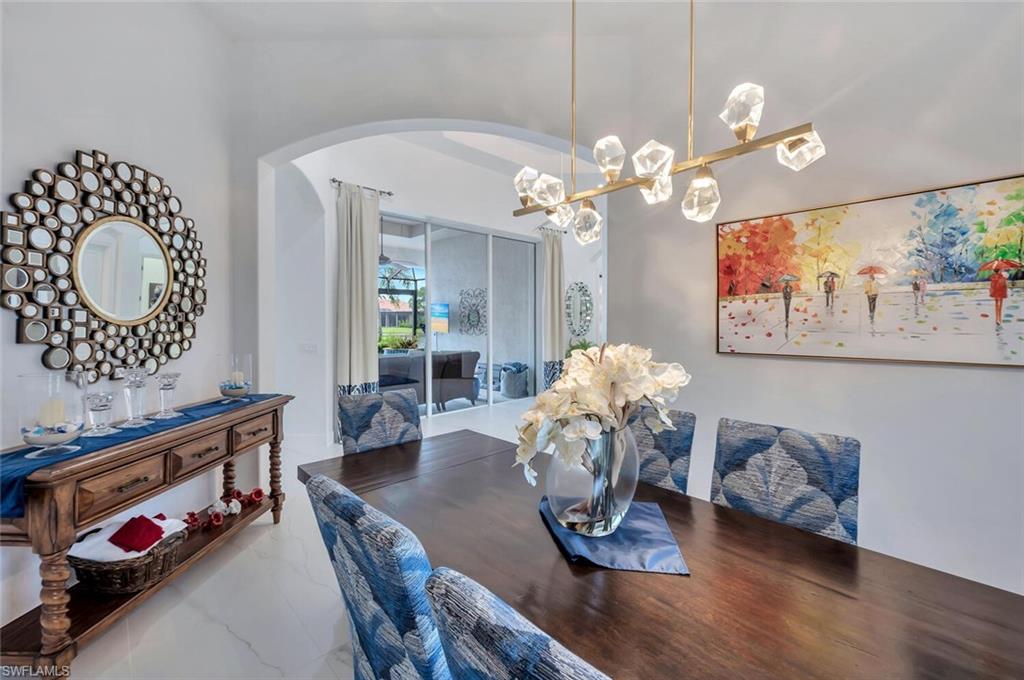 8957 Shenendoah Circle Naples, FL 34113 - Photo 11 of 50 a dining room with furniture and wooden floor