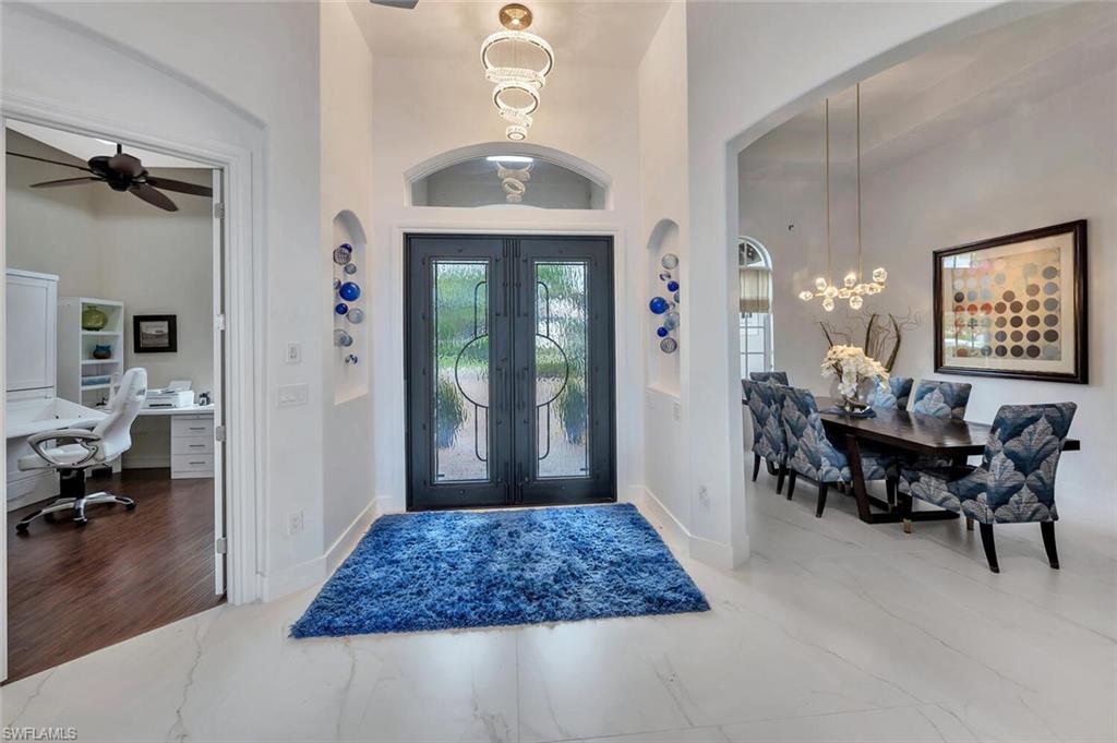 8957 Shenendoah Circle Naples, FL 34113 - Photo 12 of 50 a workspace with furniture and a chandelier
