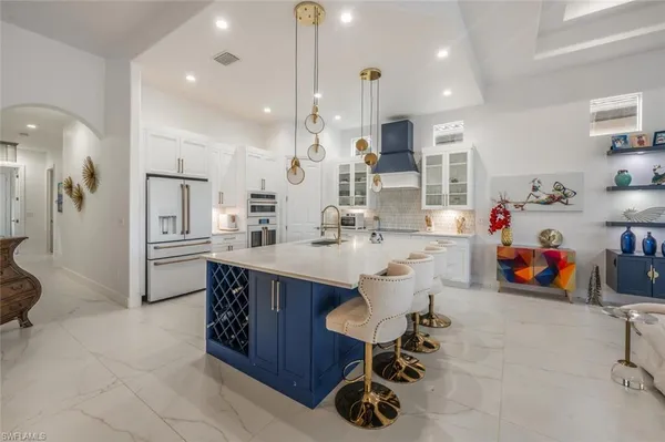 a kitchen with stainless steel appliances kitchen island granite countertop a sink and cabinets