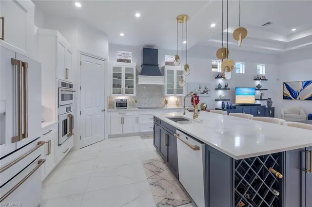 a kitchen with stainless steel appliances a refrigerator sink and cabinets