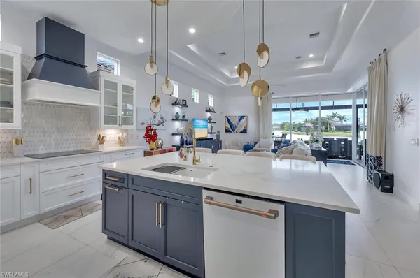 a large kitchen with kitchen island a island a sink a stove and a large window