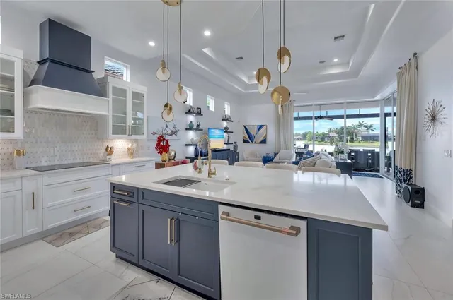 a large kitchen with kitchen island a island a sink a stove and a large window