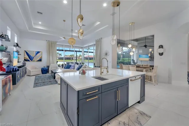 a view of a dining room and livingroom with furniture wooden floor a chandelier