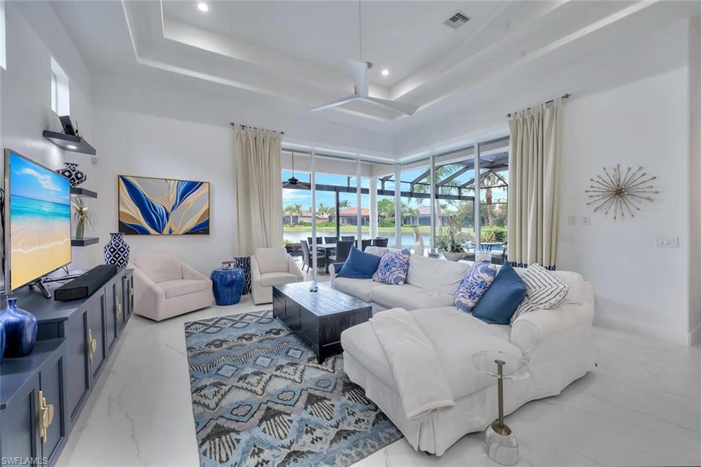 8957 Shenendoah Circle Naples, FL 34113 - Photo 23 of 50 a living room with furniture and a flat screen tv
