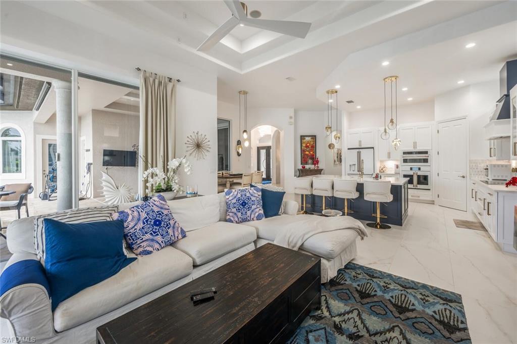 8957 Shenendoah Circle Naples, FL 34113 - Photo 25 of 50 a living room with furniture kitchen view and a chandelier