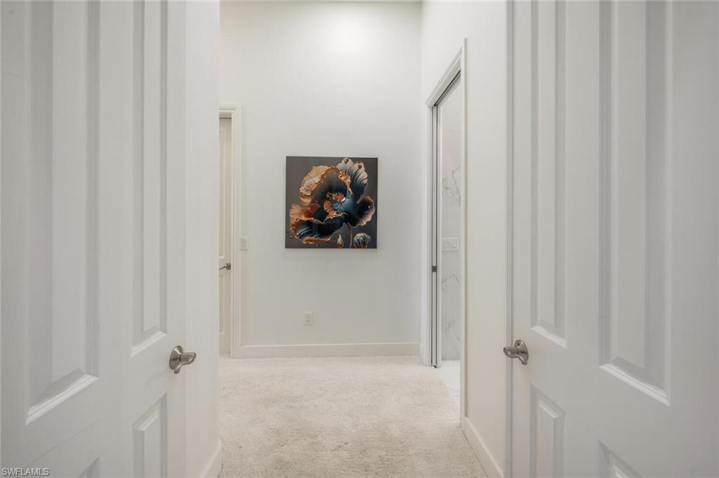 8957 Shenendoah Circle Naples, FL 34113 - Photo 26 of 50 a view of a hallway with wooden floor and closet