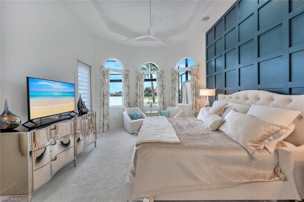 8957 Shenendoah Circle Naples, FL 34113 - Photo 27 of 50 a bedroom with bed and flat screen tv