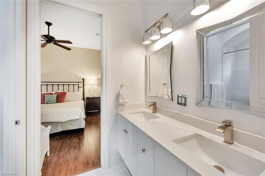 8957 Shenendoah Circle Naples, FL 34113 - Photo 32 of 50 a en suite bathroom with a double vanity sink and a mirror
