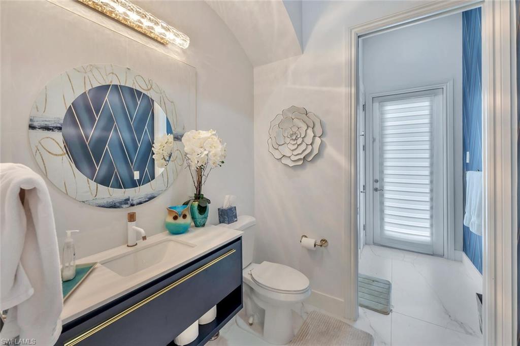 8957 Shenendoah Circle Naples, FL 34113 - Photo 36 of 50 a bathroom with a sink a toilet and a mirror