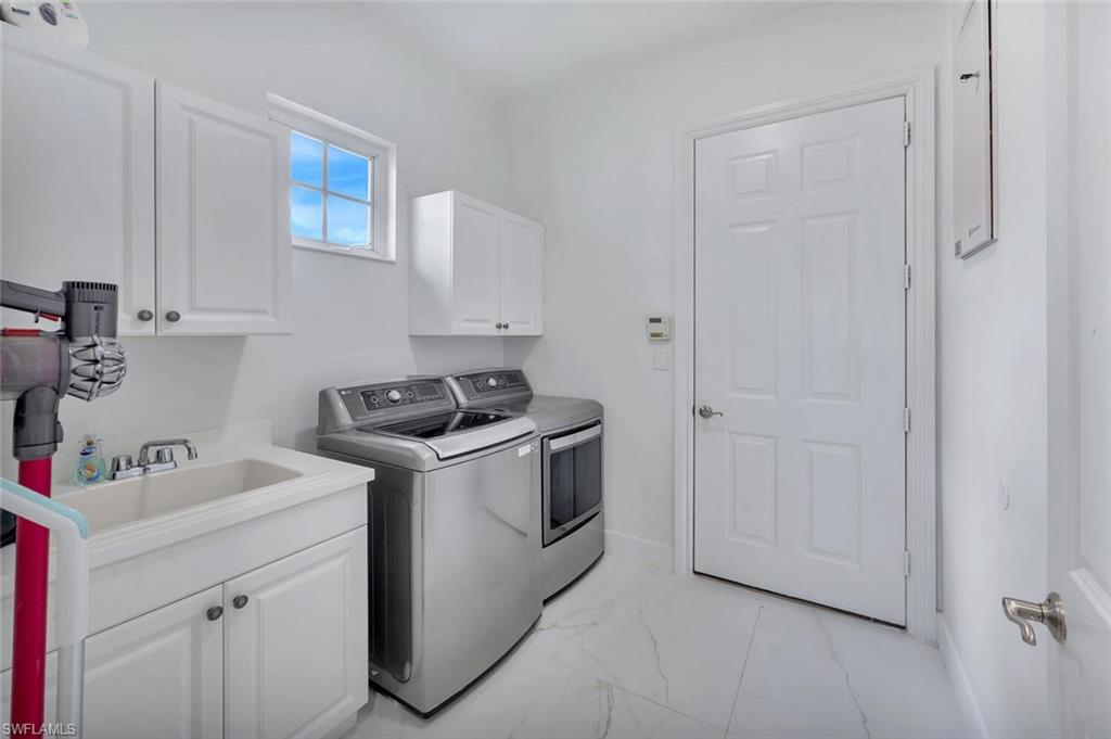 8957 Shenendoah Circle Naples, FL 34113 - Photo 37 of 50 a utility room with sink dryer and washer